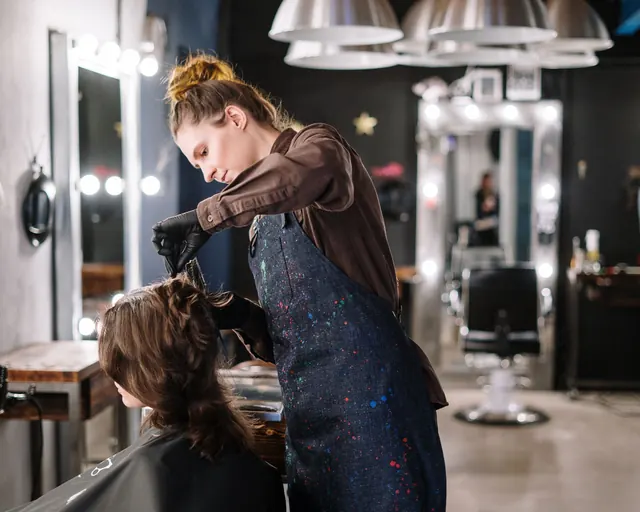 A stylist working with a client in a hair salon