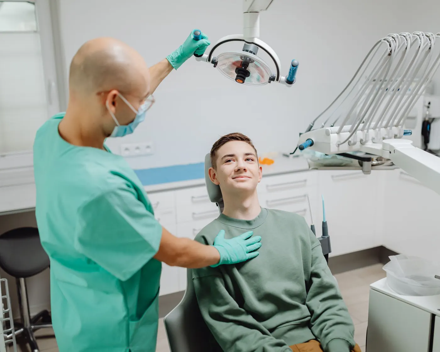 A dentist checking a patient in a bright dental clinic