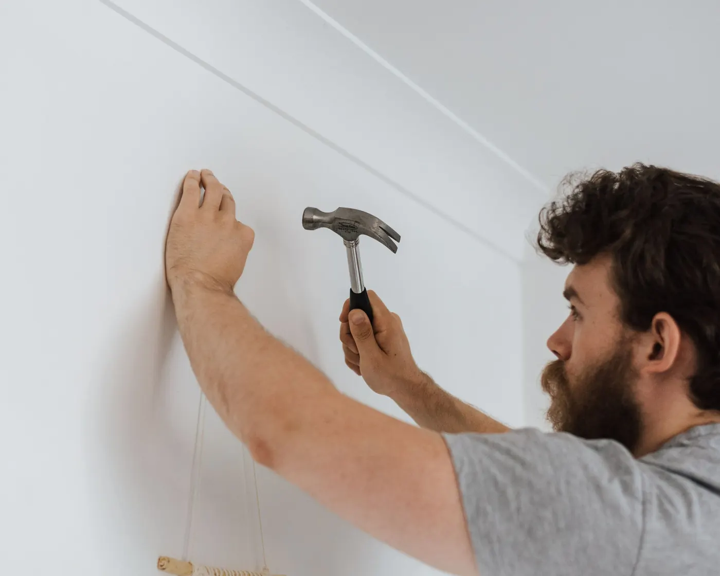 A handyman fixing a wall in a customer's home