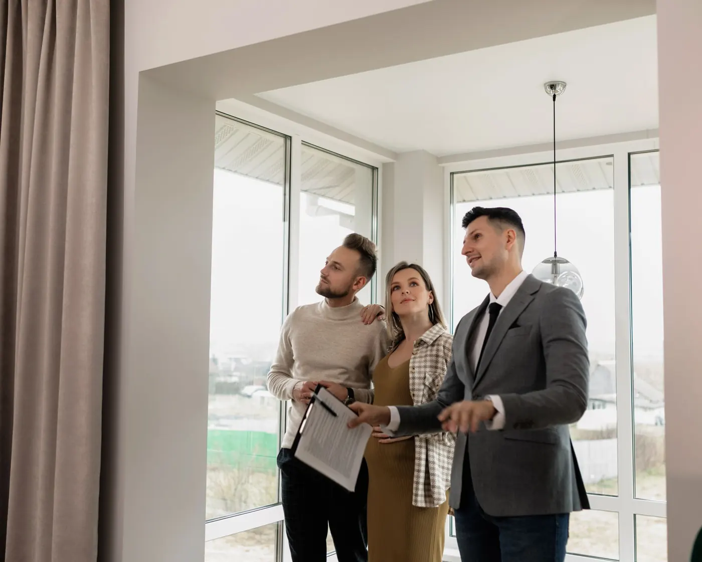 An estate agent showing a couple round a home